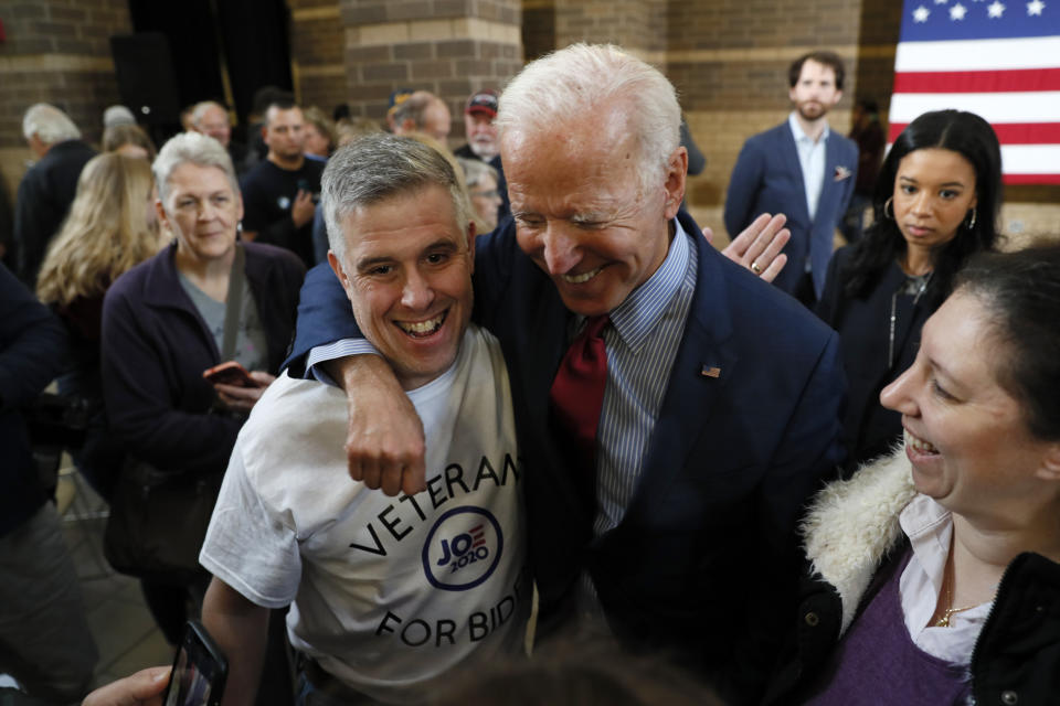 Democratic presidential candidate former Vice President Joe Biden laughs with Jeno Berta, of Bettendorf, Iowa, left, during a community event, Wednesday, Oct. 16, 2019, in Davenport, Iowa. (AP Photo/Charlie Neibergall)