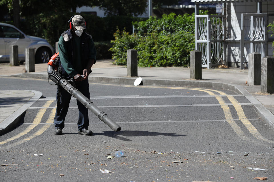 Volunteers clean up in Overton Road, Angell Town, Brixton, south London, where riots and violent confrontations with police took place overnight. Fifteen officers were injured and four people were arrested following the incident.