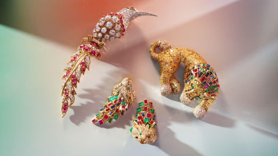 A Van Cleef & Arpels ruby and diamond "Bird of Paradise" brooch, a René Boivin multi-gem lion brooch and a pair of unsigned lionhead earrings. - Courtesy Christie's