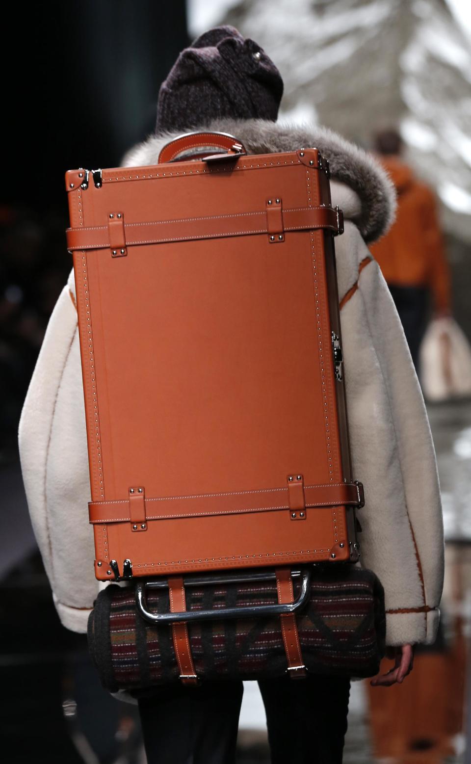 A model presents a back case by British fashion designer Kim Jones for Louis Vuitton's fall-winter 2013/2014 men's fashion collection, presented in Paris, Thursday, Jan.17, 2013. (AP Photo/Jacques Brinon)