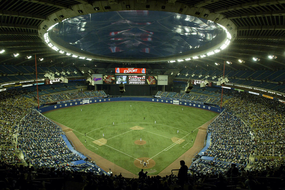 FILE - In this Sept. 29, 2004, file photo, fans watch a baseball game between the Montreal Expos and Florida Marlins at Olympic Stadium in Montreal. The Tampa Bay Rays have received permission from Major League Baseball's executive council to explore a plan that could see the team split its home games between the Tampa Bay area and Montreal, reports said Thursday, June 20, 2019. (Paul Chiasson/The Canadian Press via AP, File)