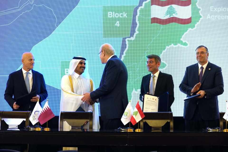 FILE - Lebanese caretaker Prime Minister Najib Mikati, center, shakes hands with Qatar's Minister of State for Energy Affairs Saad Sherida al-Kaabi, second, as Claudio Descalzi, the CEO of Italy's state-run energy company, ENI, left, Lebanese caretaker Energy Minister Walid Fayad, second right, and TotalEnergies CEO Patrick Pouyanne, right, attend to sign an agreement in Beirut, Lebanon, Sunday, Jan. 29, 2023. (AP Photo/Bilal Hussein, File)