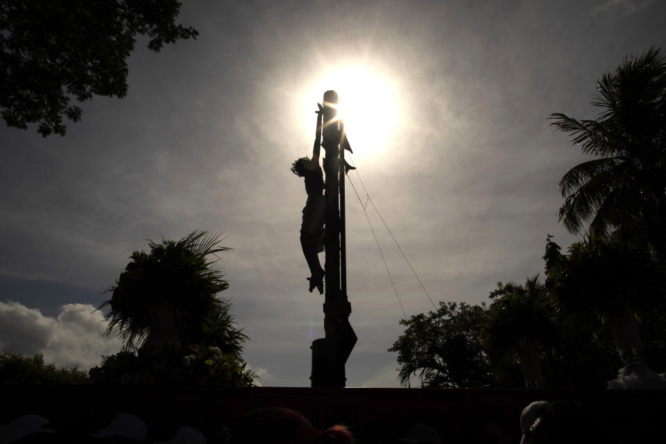 A crucifix is silhouetted against a mid-day sky during in an event marking Good Friday at the Metropolitan Cathedral in Managua, Nicaragua, Friday, April 7, 2023. Holy Week commemorates the last week of the earthly life of Jesus, culminating in his crucifixion on Good Friday and his resurrection on Easter Sunday. (AP Photo/Inti Ocon)