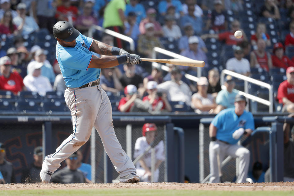 Miami Marlins' Jesus Aguilar singles during the fourth inning of a spring training baseball game against the Washington Nationals Monday, March 2, 2020, in West Palm Beach, Fla. (AP Photo/Jeff Roberson)