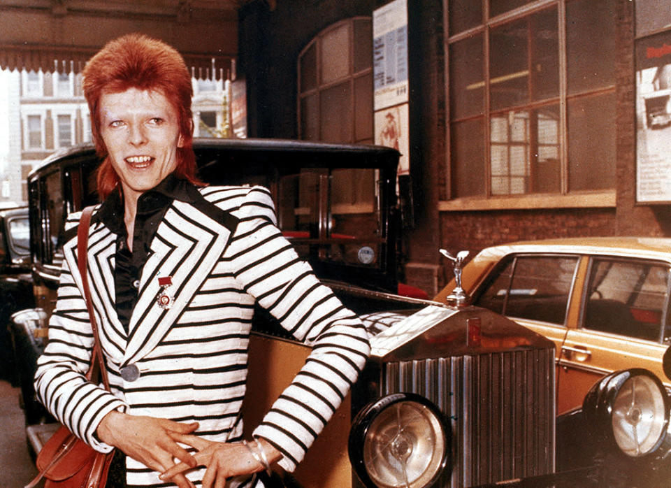 ‘Ziggy’-era, flame-haired Bowie poses beside his Rolls Royce in May 1973.