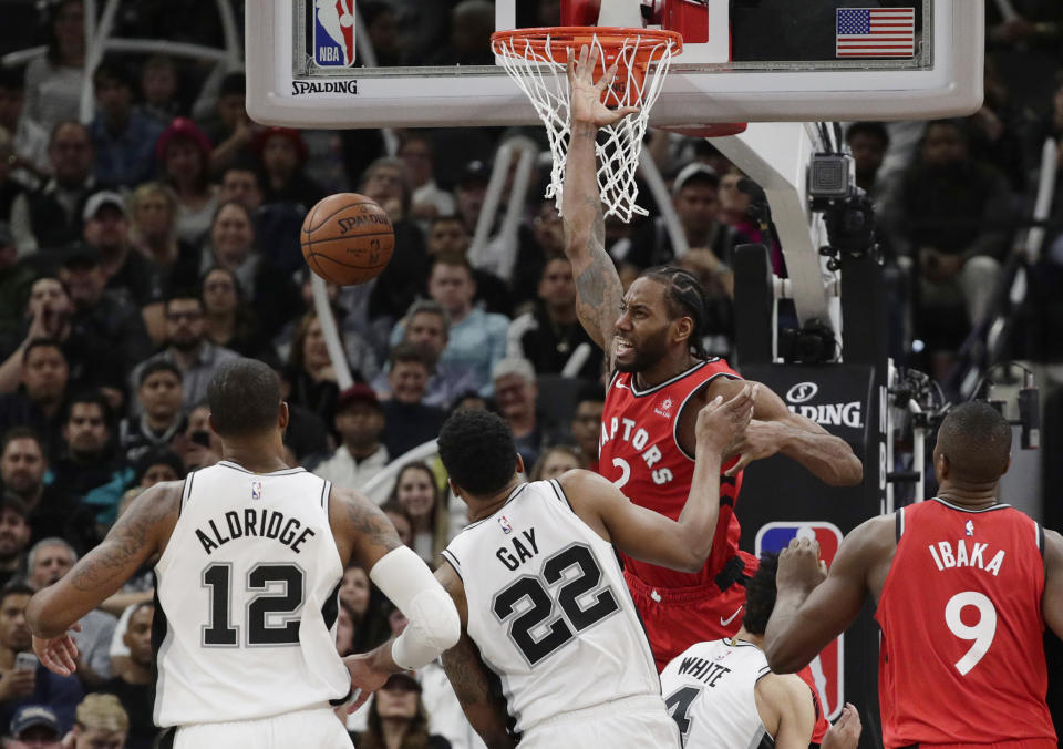 Toronto Raptors forward Kawhi Leonard (2) reacts as he loses control of the ball while trying to score against the San Antonio Spurs during the second half of an NBA basketball game Thursday, Jan. 3, 2019, in San Antonio. (AP Photo/Eric Gay)