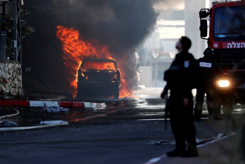 A vehicle burns after a factory caught on fire in Sderot, southern Israel