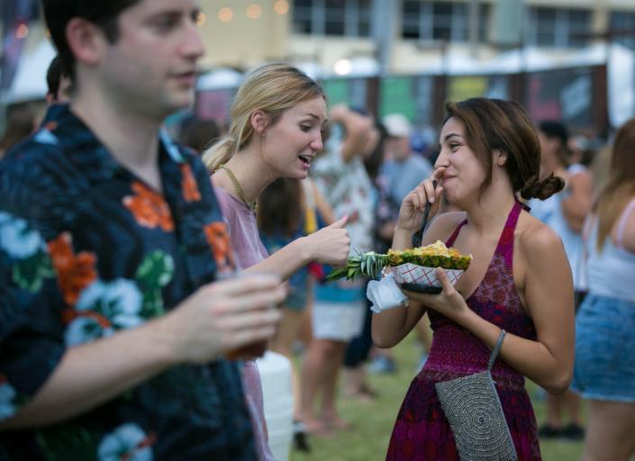 SunFest fans share a fest-favorite dish -- the Tropical Pineapple Chicken -- during the 2016 season.