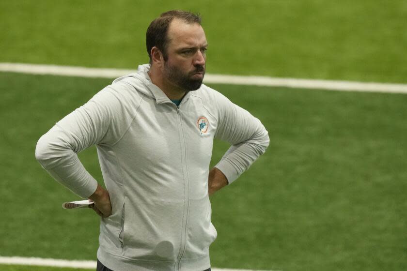 Miami Dolphins offensive coordinator Frank Smith watches practice.