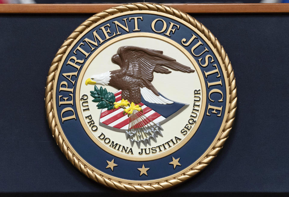 FILE - The Department of Justice seal is seen before a news conference to announce an international ransomware enforcement action at the Department of Justice in Washington, Jan. 26, 2023. On Friday, July 21, The Associated Press reported on stories circulating online incorrectly claiming the U.S. Department of Justice said international child sex trafficking is not an area of concern. (AP Photo/Jose Luis Magana, File)