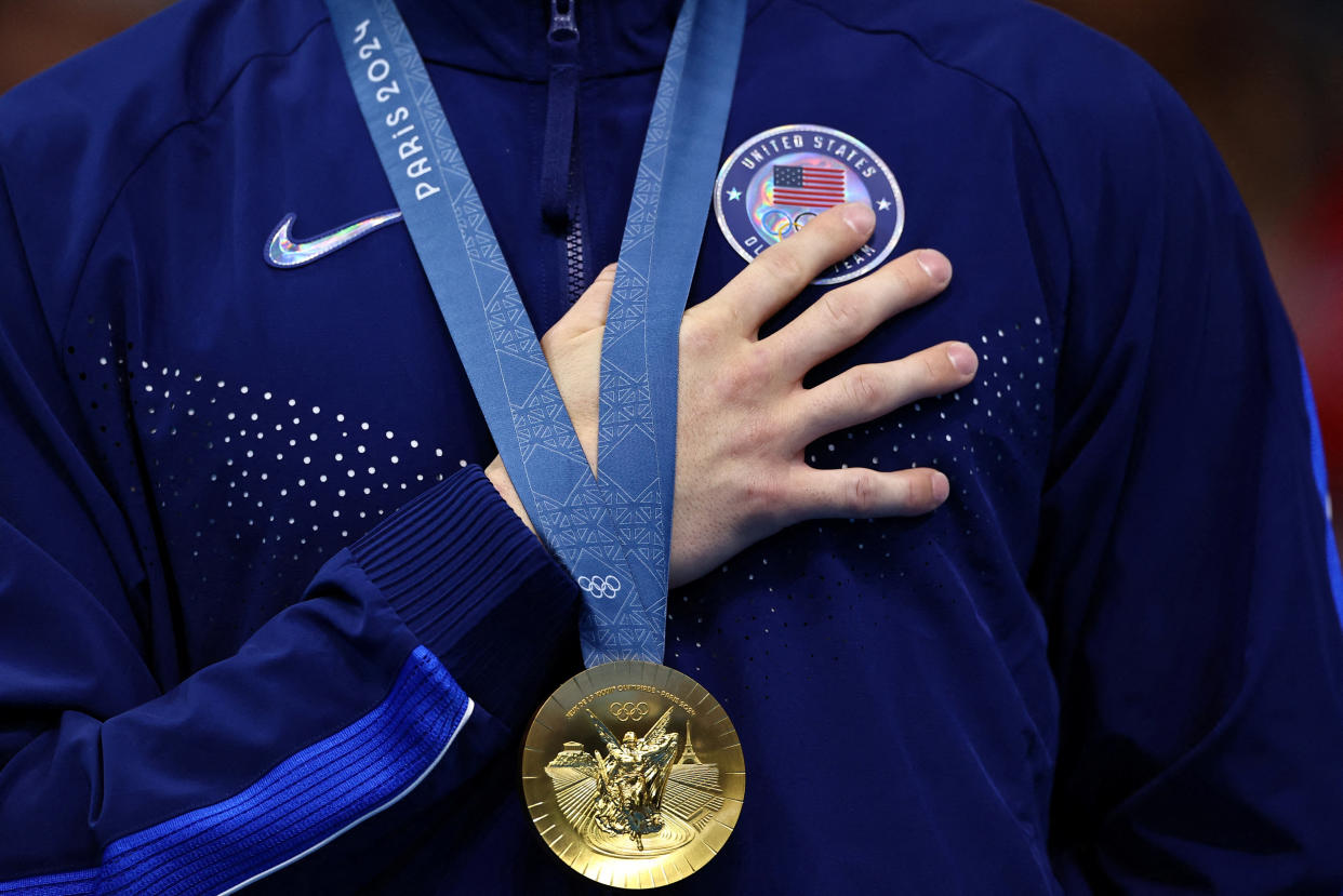 U.S. gold medalist Bobby Finke celebrates at the men's 1500m freestyle victory ceremony after winning the medal and establishing a world record on Sunday.