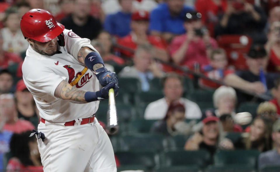 St. Louis Cardinals' Yadier Molina swings for a base hit in the seventh inning of a baseball game against the San Francisco Giants, Friday, July 16, 2021, in St. Louis. The single was Molina's 2065th career hit, moving him into fifth place, past Enos Slaughter, on the Cardinals' all-time hit list. (AP Photo/Tom Gannam)