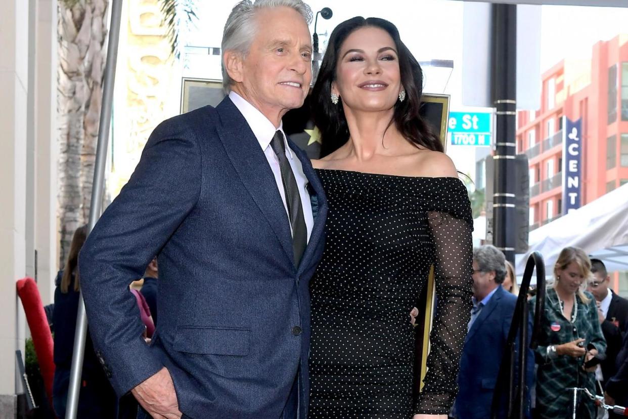 Michael Douglas and Catherine Zeta-Jones pose for a photo at the Hollywood Walk of Fame Ceremony honoring Michael Douglas on Hollywood Boulevard on 6 November, 2018 in Hollywood, California: (Photo by Charley Gallay/Getty Images for Netflix)
