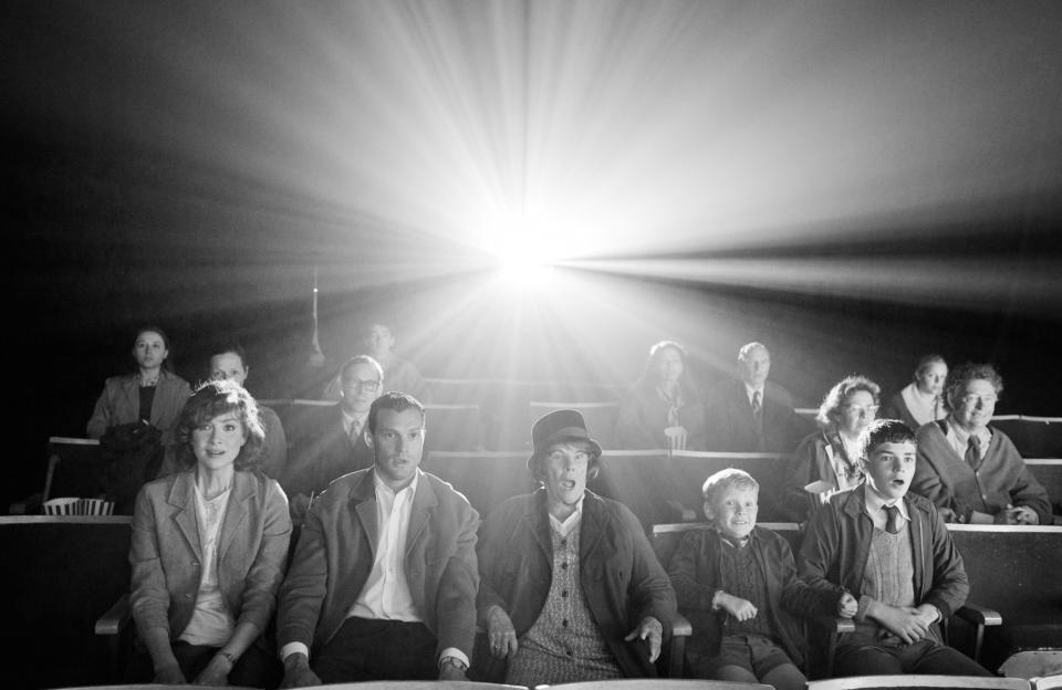 The family sitting in a movie theater with astonished looks on their faces