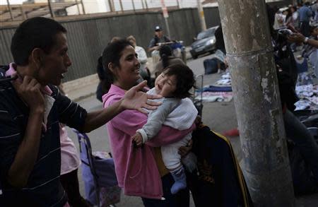 Peruvian immigrants sell clothes along a street, in the Bras neighbourhood of Sao Paulo early morning August 9, 2013. REUTERS/Nacho Doce