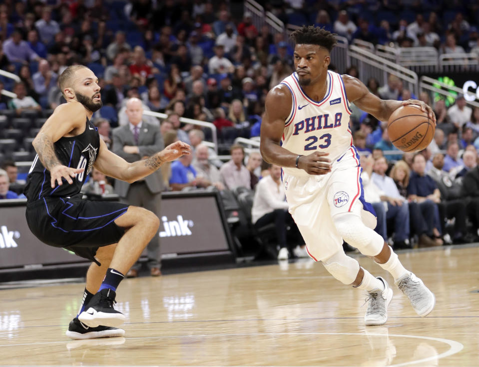 Philadelphia 76ers’ Jimmy Butler (23) drives past Orlando Magic’s Evan Fournier, left, during the first half of an NBA basketball game, Wednesday, Nov. 14, 2018, in Orlando, Fla. (AP Photo/John Raoux)