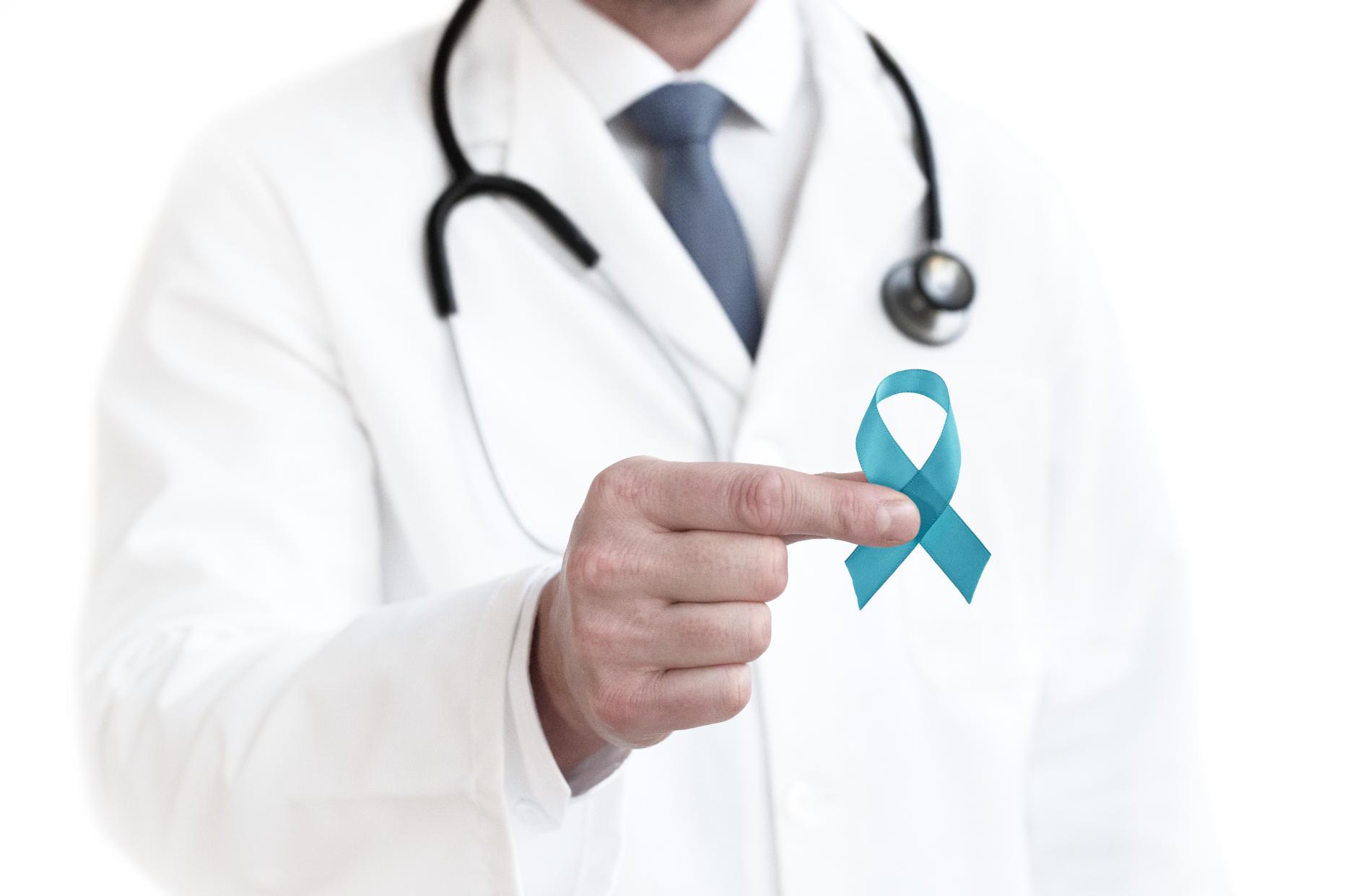 Doctor holding an ovarian cancer awareness ribbon.