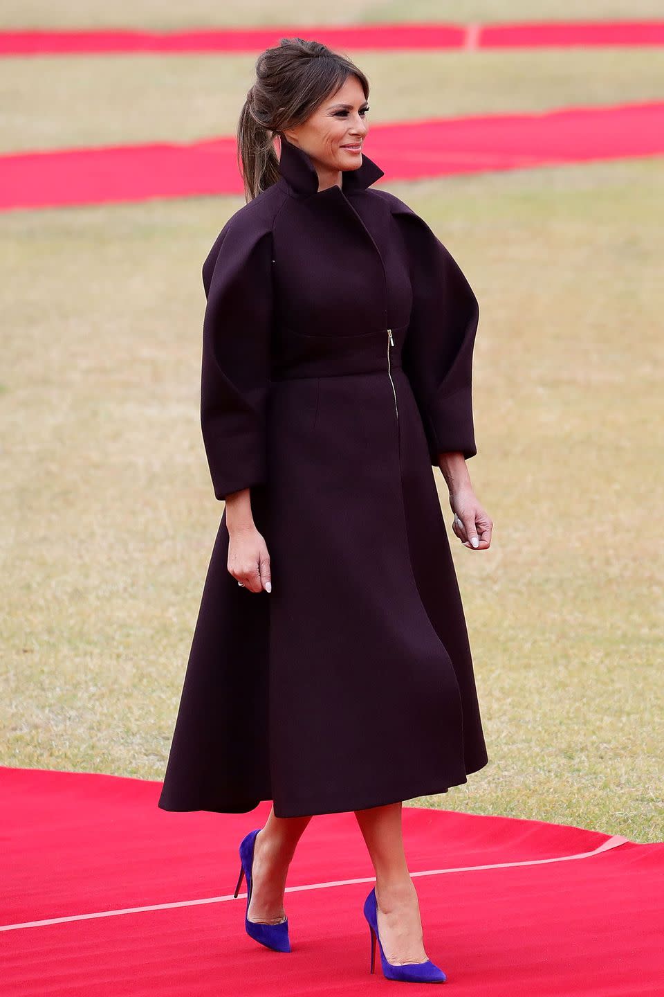 <p>Arriving in South Korea, FLOTUS wore a deep burgundy Delpozo coat dress paired with blue-violet stiletto pumps. Look familiar? She wore a bright fuchsia dress from the brand in a similar silhouette for her <a href="https://www.townandcountrymag.com/society/politics/a12444274/melania-trump-united-nations-speech/" rel="nofollow noopener" target="_blank" data-ylk="slk:United Nations speech" class="link ">United Nations speech</a> back in September.</p>