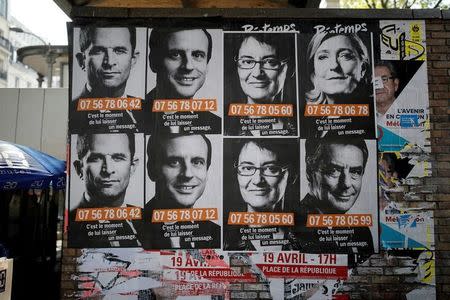 A poster campaign with factice portable cellphone numbers for French presidential candidates, Top row from L, Benoit Hamon, Socialist Party candidate, Emmanuel Macron, candidate for "En Marche !" or (Onwards !), Nathalie Arthaud, candidate for France's extreme-left Lutte Ouvriere, and Marine Le Pen, the National Front (FN) leader and candidate; Bottom row R, Francois Fillon, the Republicans centre-right candidate, are seen on a wall in Paris, France, April 19, 2017. REUTERS/Benoit Tessier