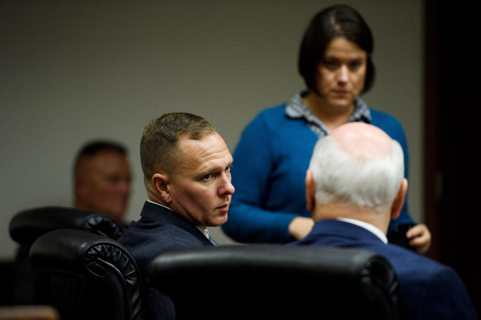Suspended Greenville Sheriff Will Lewis speaks to his attorney, Rauch Wise, before court resumes on Thursday afternoon, Oct. 24, 2019, in Greenville, S.C. Lewis, 43, said he did not plan to have sex with his young female assistant at an out-of-town budget conference, but one thing led to another after they went out for drinks and ended up in her hotel room.(Josh Morgan/The Greenville News via AP, Pool)