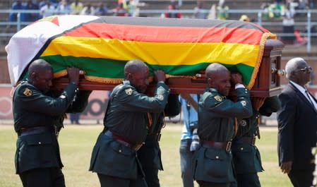 A casket carrying the remains of Robert Mugabe is brought to lie in state at the at Rufaro stadium