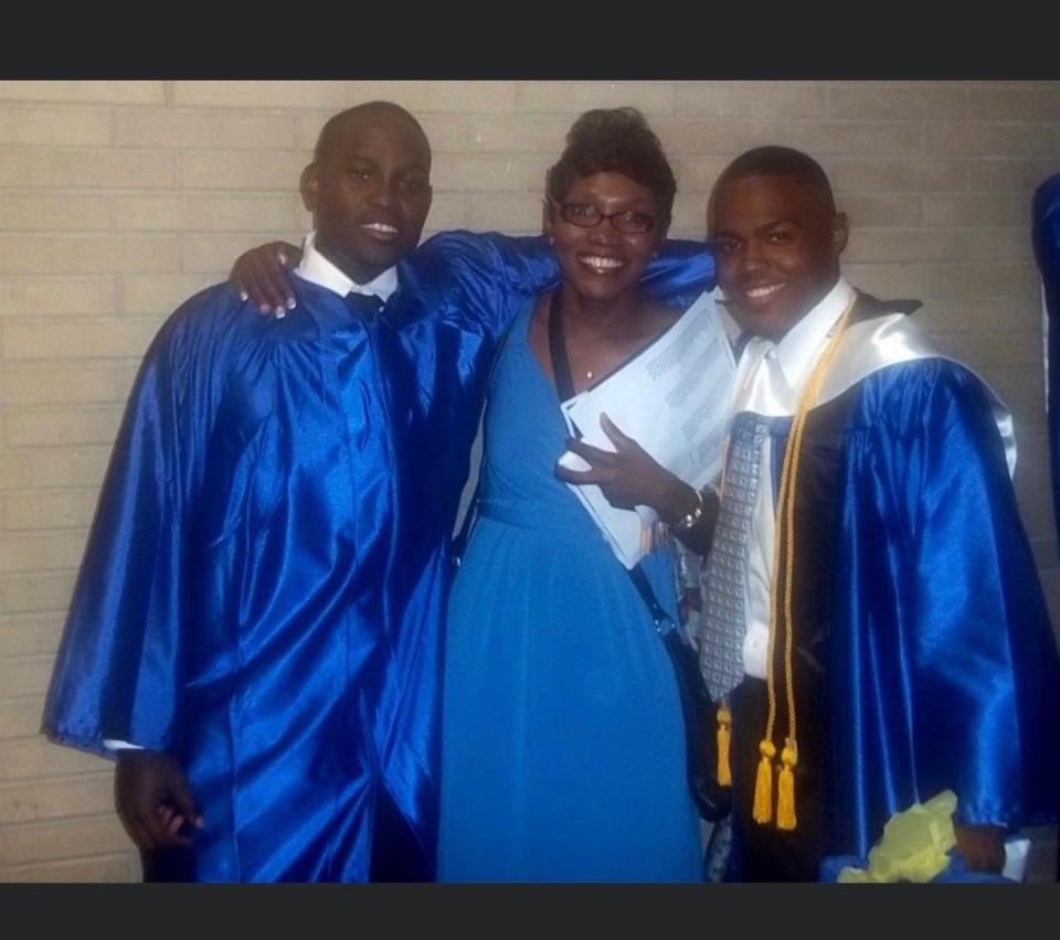 From left Ahmaud Arbery, his mother Wanda Cooper-Jones and his best friend Akeem Baker pose at their high school graduation.