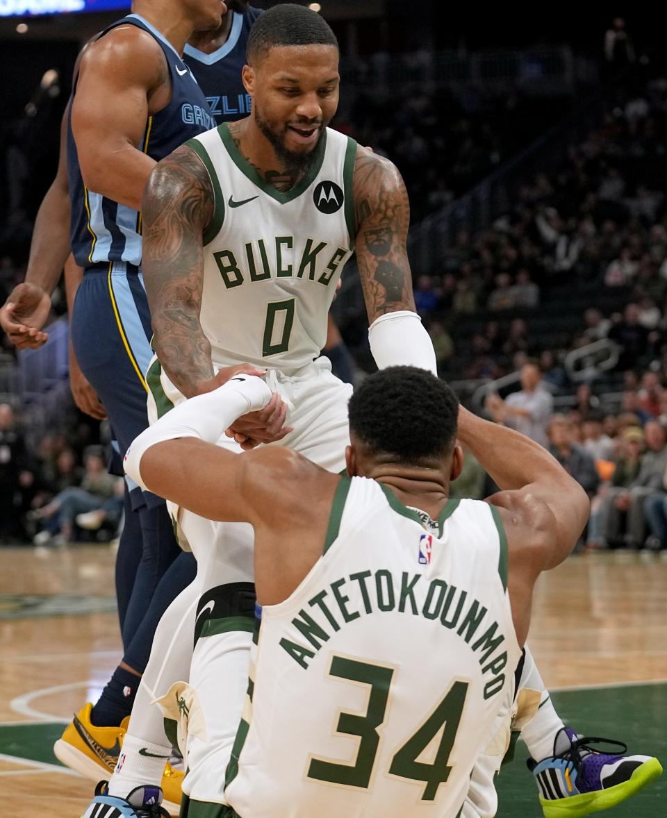 Milwaukee Bucks guard Damian Lillard (0) gives an assist to forward Giannis Antetokounmpo (34) after he was fouled during the first half of their preseason game against the Memphis Grizzlies Friday, October 20, 2023 at Fiserv Forum in Milwaukee, Wisconsin.



Mark Hoffman/Milwaukee Journal Sentinel