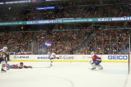 Jan 18, 2019; Washington, DC, USA; New York Islanders right wing Cal Clutterbuck (15) scores a goal on Washington Capitals goaltender Braden Holtby (70) in the third period at Capital One Arena. The Islanders won 2-0. Mandatory Credit: Geoff Burke-USA TODAY Sports