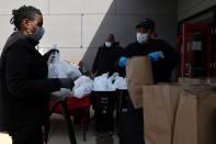 Volunteers distribute food to people in need during the coronavirus disease (COVID-19) outbreak from the Maya Angelou charter school in Washington