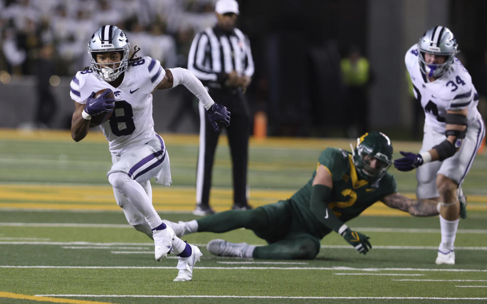 Kansas State wide receiver Phillip Brooks runs downfield past Baylor linebacker Matt Jones and tight end Ben Sinnott, right, in the first half of an NCAA college football game, Saturday, Nov.12, 2022, in Waco, Texas. (Rod Aydelotte/Waco Tribune-Herald via AP)