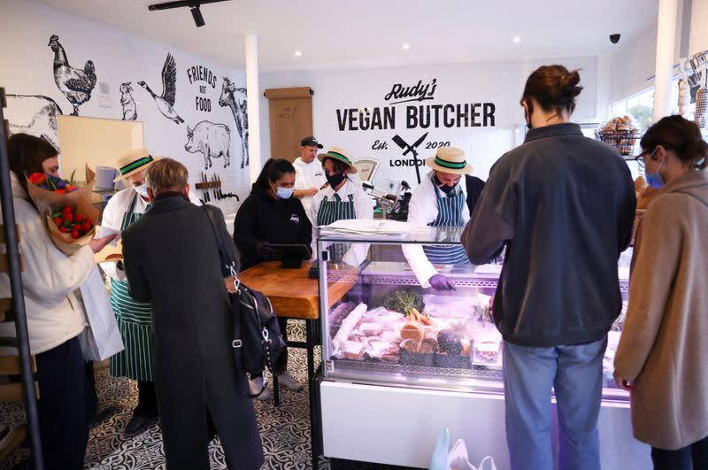 Customers are served inside 'Rudy's Vegan Butcher' shop, amid the coronavirus (COVID-19) outbreak, in London