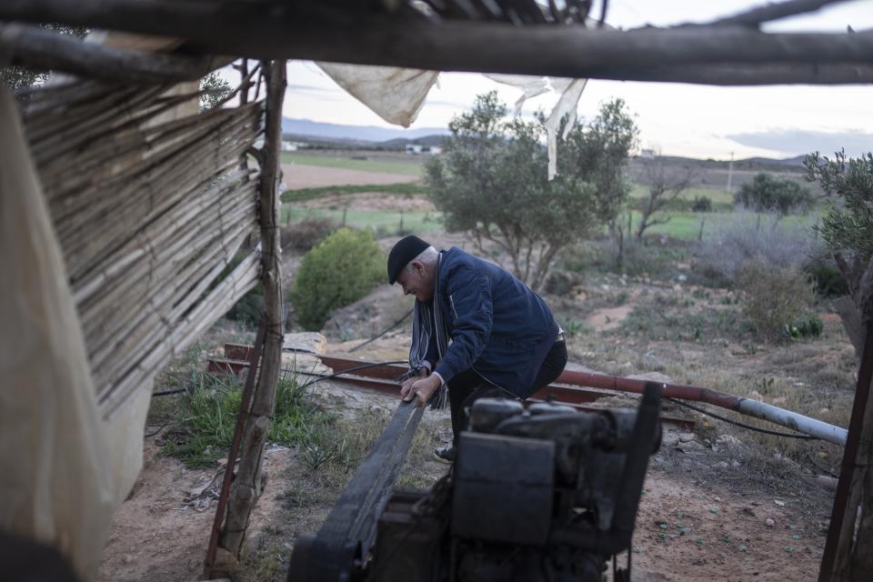 Mimoun Nadori starts his water pump outside his home, in Nador, north of Morocco, Friday, March 8, 2024. (AP Photo/Mosa'ab Elshamy)