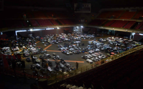 Residents seek shelter inside Roberto Clemente Coliseum in San Juan, - Credit: HECTOR RETAMAL/AFP