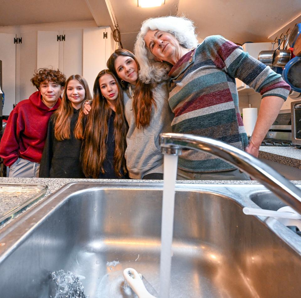 Betty Ludtke of Hyannisport with her children (from left) Nate, 17, Augusta, 11, Sophia, 11 and Anya, 14, in their kitchen on Wednesday. They were part of a PFAS health study that revealed the concentration of the chemical in their blood. Hyannis and Ayer are two Massachusetts municipalities where residents were exposed to high levels of PFAS in drinking water.