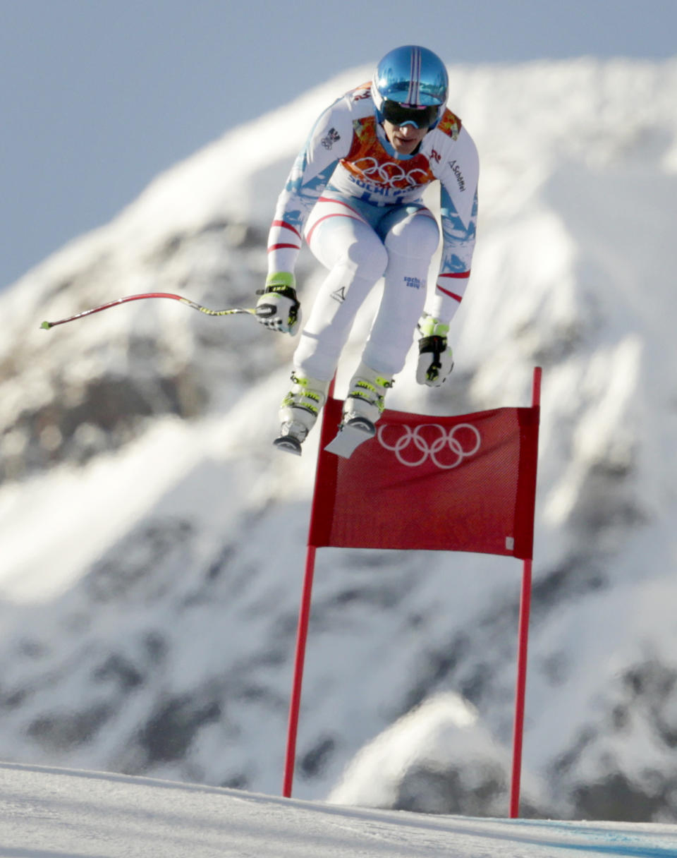 Austria's Matthias Mayer makes a jump during a men's downhill training run for the Sochi 2014 Winter Olympics, Friday, Feb. 7, 2014, in Krasnaya Polyana, Russia. (AP Photo/Charles Krupa)