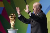 Spain's coach Vicente del Bosque gestures next to the World Cup trophy during the draw for the 2014 World Cup at the Costa do Sauipe resort in Sao Joao da Mata, Bahia state, December 6, 2013. REUTERS/Ricardo Moraes