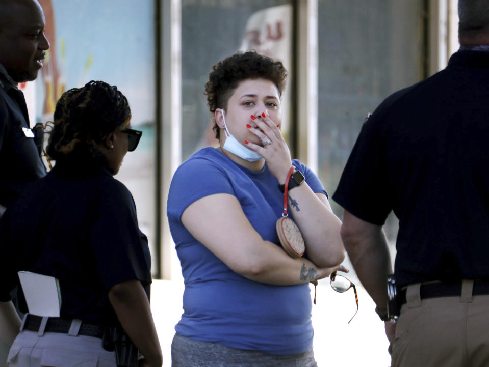 Family members of victims wait with Memphis Police Department officers outside of a post office after a shooting, Tuesday, Oct. 12, 2021 in the Orange Mound neighborhood of Memphis, Tenn. Police investigated a shooting Tuesday at a post office in an historic neighborhood of Memphis, Tennessee, the third high-profile shooting in the region in weeks.(Patrick Lantrip/Daily Memphian via AP)