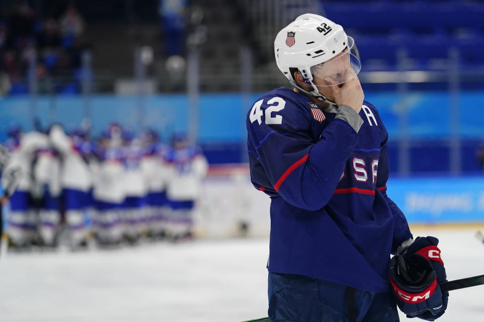 United States' Aaron Ness (42) leaves the ice as Slovakia players celebrate behind him after a men's quarterfinal hockey game at the 2022 Winter Olympics, Wednesday, Feb. 16, 2022, in Beijing. Slovakia won 3-2 in a shoot-out. (AP Photo/Matt Slocum)