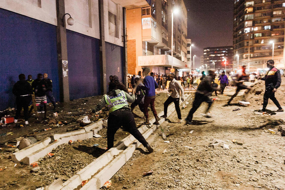 Image: South Africa Police Services officers stop looters from looting in central Durban, South Africa (AFP - Getty Images)