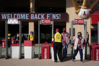 A security guard moves a barrier to allow fans to leave Angel Stadium when a baseball game between the Minnesota Twins and the Los Angeles Angels was postponed Saturday, April 17, 2021, in Anaheim, Calif. MLB said the game was postponed to allow for continued COVID-19 testing and contact tracing involving members of the Twins organization. (AP Photo/Ashley Landis)