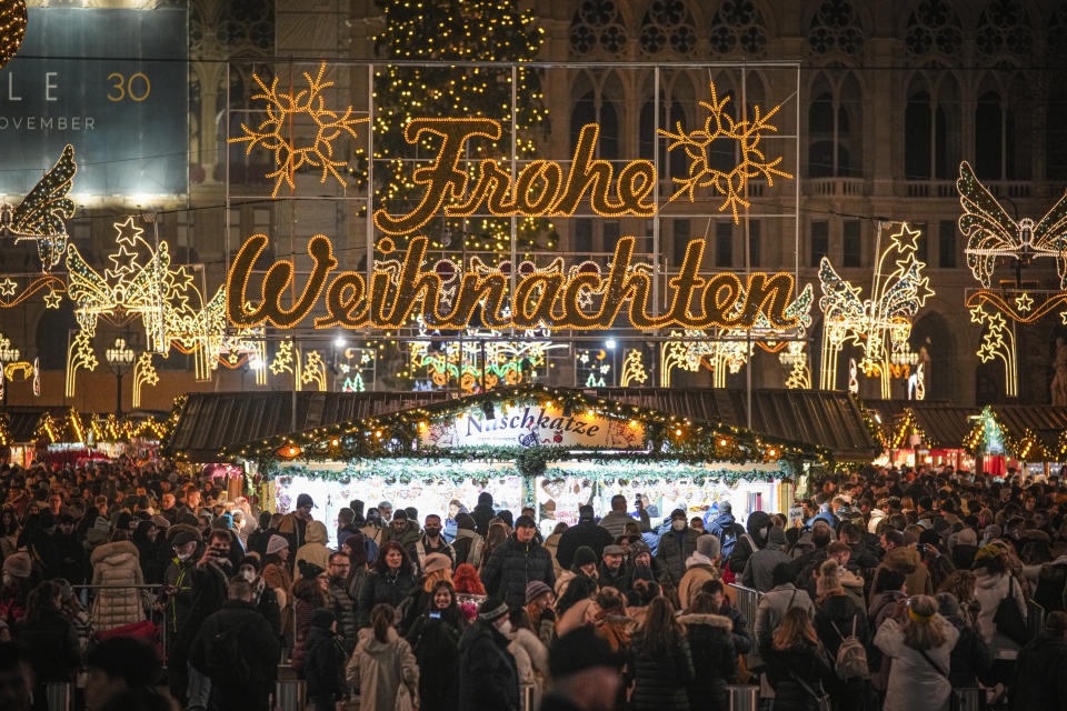 People crowd a Christmas market in Vienna, Austria, Sunday, Nov. 21, 2021. The Austrian government announced a nationwide lockdown that will start Monday and comes as average daily deaths have tripled in recent weeks and hospitals in heavily hit states have warned that intensive care units are reaching capacity.(AP Photo/Vadim Ghirda)