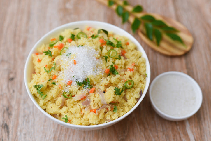 A bowl of vegetable upma, a savoury semolina based dish, that is sometimes topped with a little bit of sugar to bring out the flavours