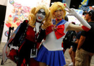 Attendees dressed as Harley Quinn (L) and Sailor Moon pose for a picture at Comic-Con. REUTERS/Mike Blake