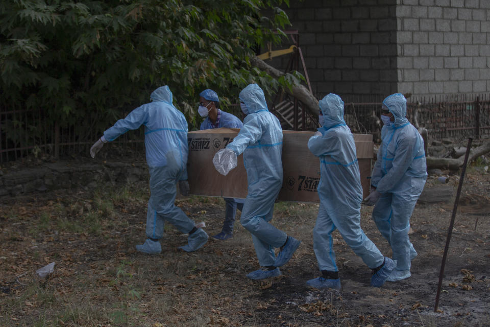 Indian paramilitary soldiers carry the body of a colleague who died of COVID-19 for cremation at a crematorium in Srinagar, Indian controlled Kashmir, Saturday, July 18, 2020. India crossed 1 million coronavirus cases on Friday, third only to the United States and Brazil, prompting concerns about its readiness to confront an inevitable surge that could overwhelm hospitals and test the country's feeble health care system. (AP Photo/ Dar Yasin)