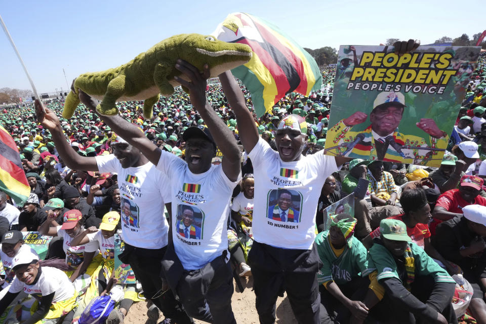 Supporters of Zimbabwean President Emmerson Mnangagwa are seen a at a campaign rally in Harare, Wednesday, Aug. 9, 2023. Mnangagwa addressed thousands of supporters in a speech laden with calls for peace, days after his supporters were accused of stoning an opposition activist to death ahead of general elections set for Aug. 23. (AP Photo/Tsvangirayi Mukwazhi)