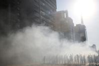 Demonstrators are seen among tear gas during a protest against Brazilian President Jair Bolsonaro in Sao Paulo