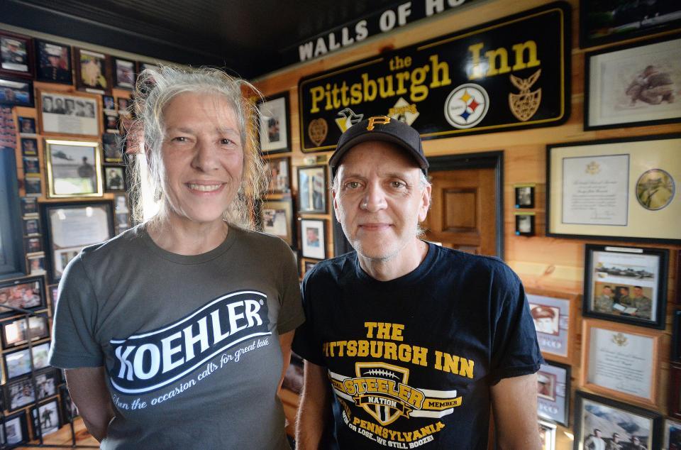 Pittsburgh Inn owners Robin and Tom Weunski have supported U.S. troops by sending care packages to adopted service members and have received many portraits from thankful soldiers, which they display.