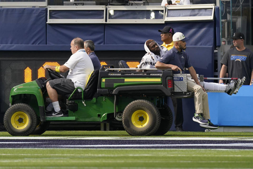 Seattle Seahawks wide receiver DK Metcalf (14) leaves the field with an injury during the first half of an NFL football game against the Los Angeles Chargers Sunday, Oct. 23, 2022, in Inglewood, Calif. (AP Photo/Mark J. Terrill)