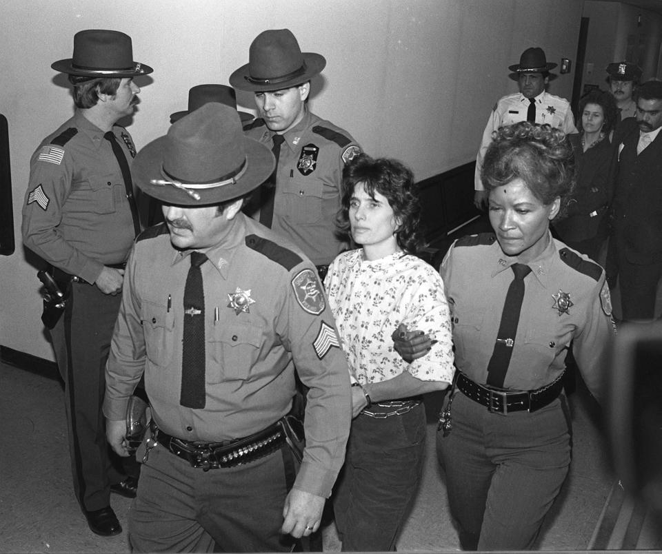 Kathy Boudin is escorted by police on Nov. 24, 1981. Journal News file photo
Kathy Boudin (floral blouse) and Judith Clarke (in background) are escorted by Rockland County Sheriffs 11/24/81.  (The Journal News File photo)