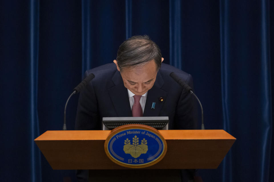 Japanese Prime Minister Yoshihide Suga bows during a press conference at the prime minister's official residence on Friday, May 14, 2021, in Tokyo. Suga announced that the current coronavirus state of emergency covering Tokyo, Osaka and a number of other areas, will be extended to the prefectures of Hokkaido, Okayama and Hiroshima from Sunday as Japan battles a fourth wave of coronavirus. (Yuichi Yamazaki/Pool Photo via AP)